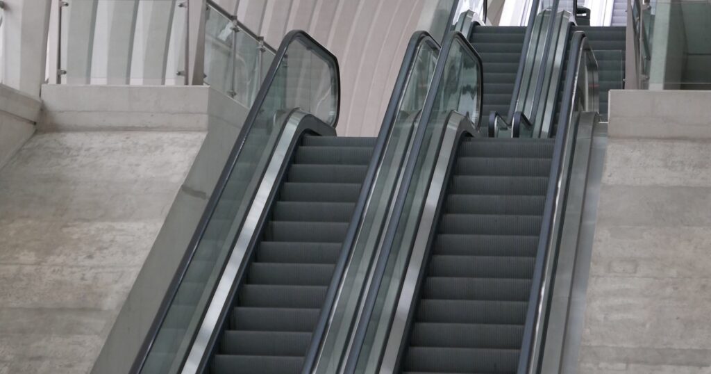 Escalator inside a white building